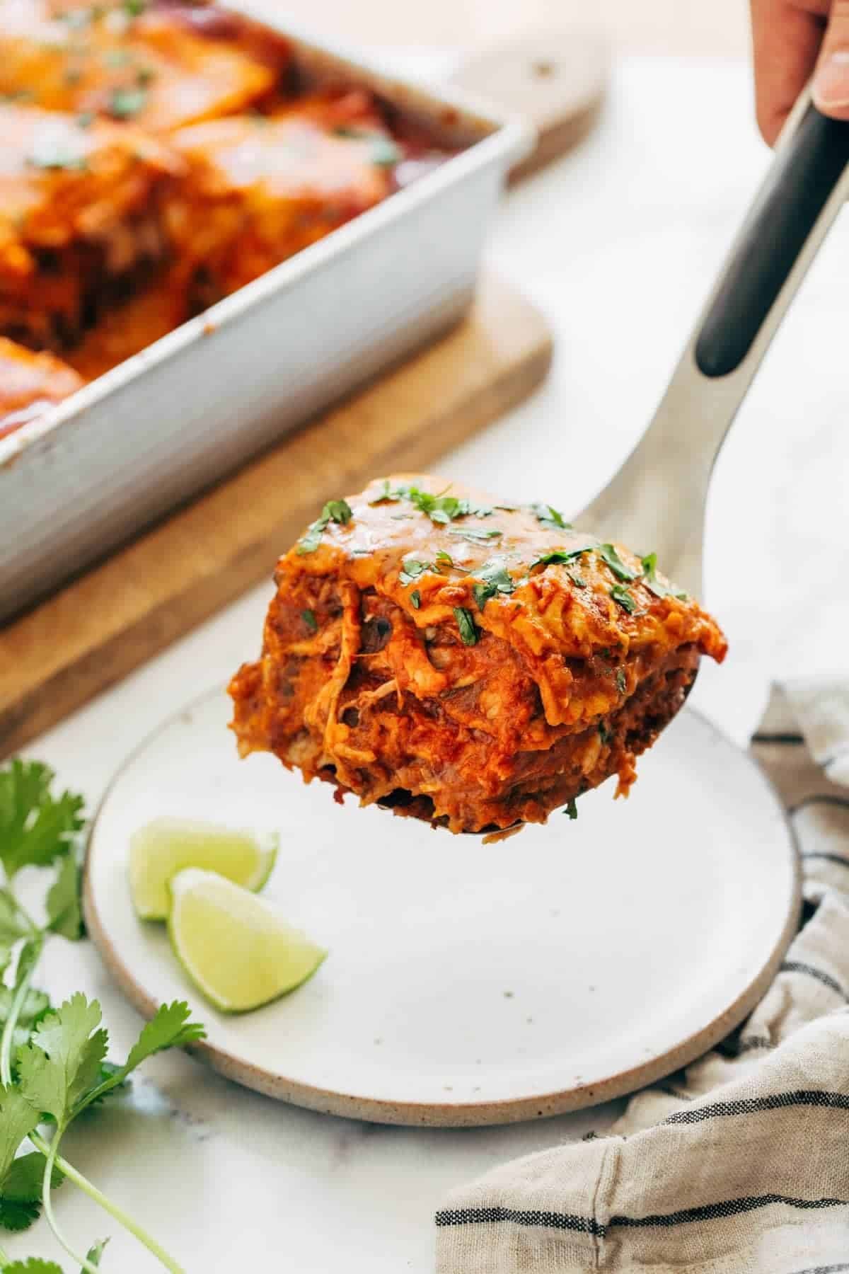 Slice of chicken enchilada casserole on a spatula.
