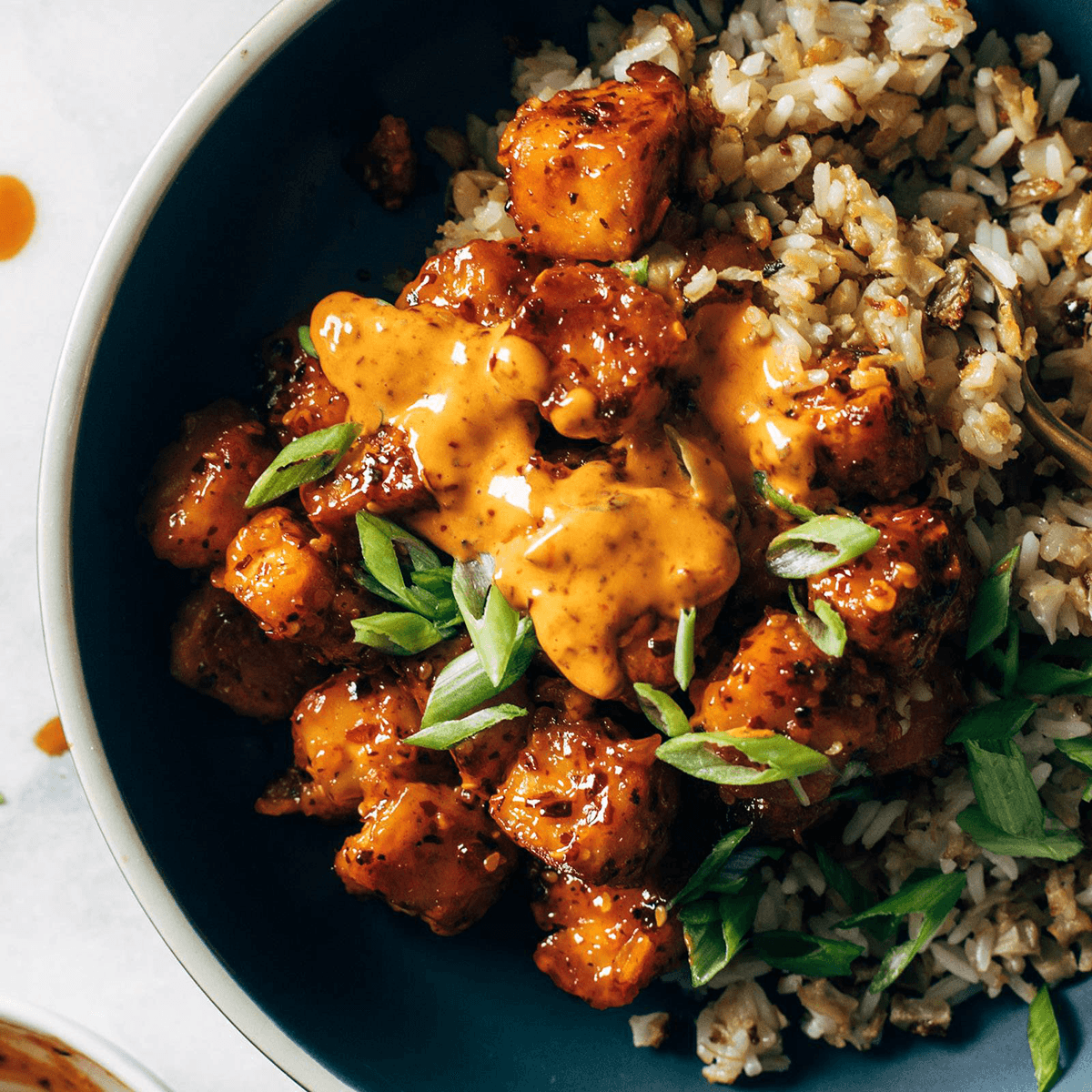 Chili crunch tofu in a bowl with rice.