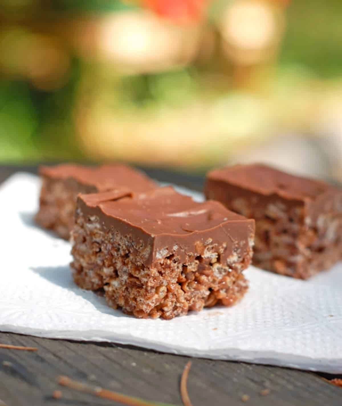 Chocolate scotcheroos on a napkin.