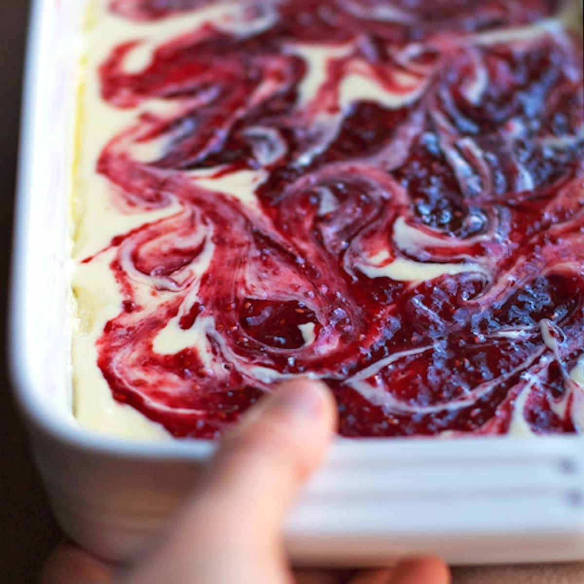 Raspberry cream cheese coffee cake in a pan.